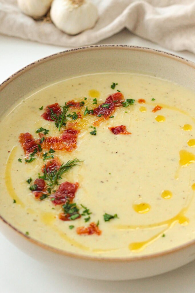 easy roasted garlic soup with bacon bits and cheddar