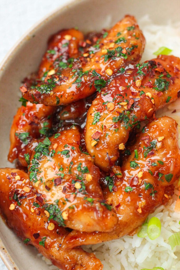 sticky honey garlic chicken tenders with rice and vegetables