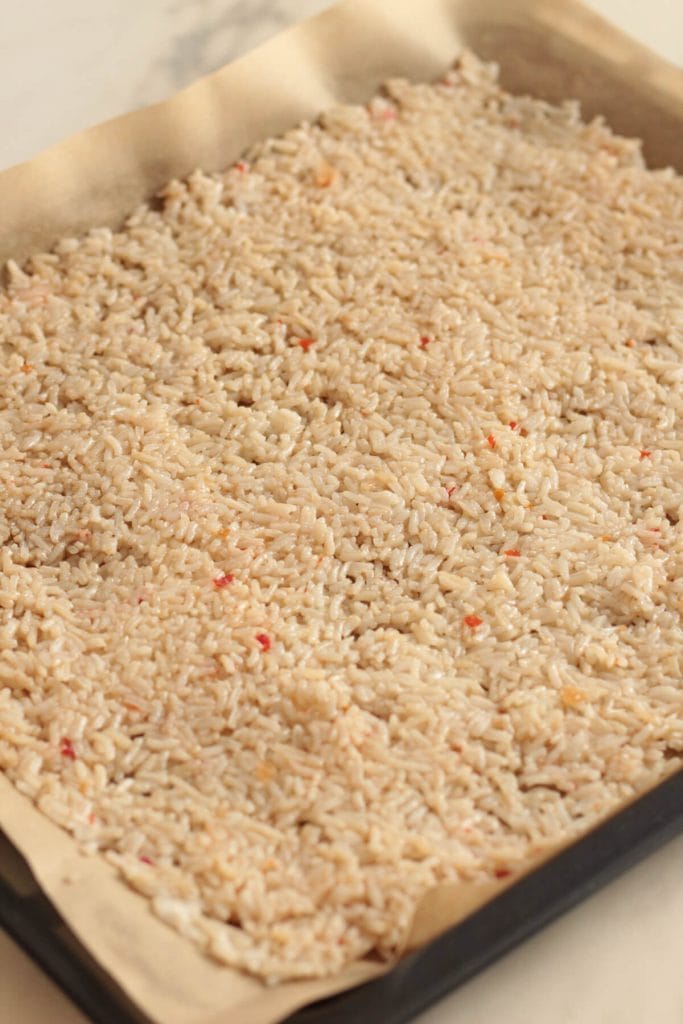 Tray of uncooked rice spread evenly