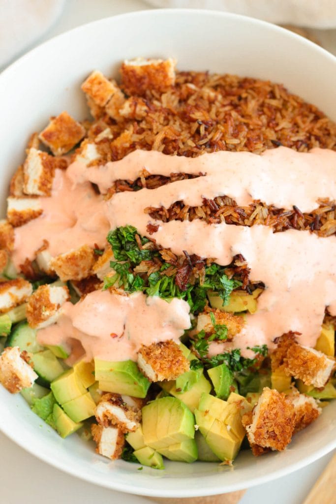 Bowl of rice, avocado, and sauce