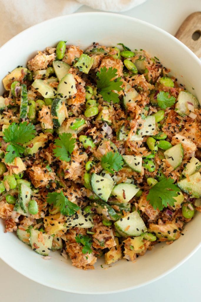 Colorful crispy rice salad with chicken, vegetables and herbs