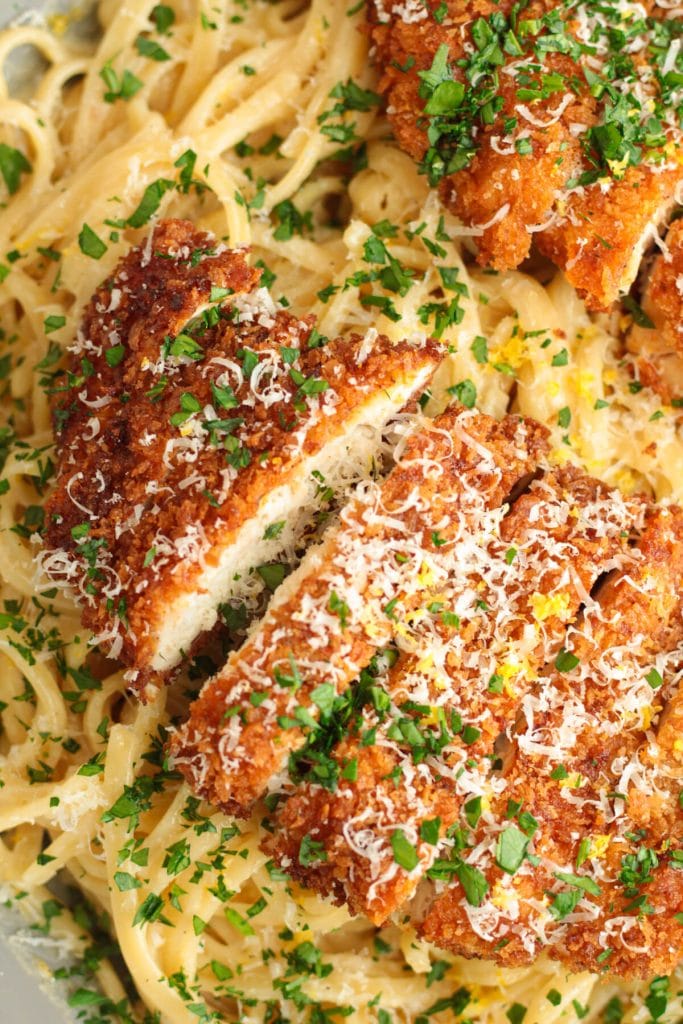 Roasted garlic lemon pasta topped with crispy chicken and herbs.