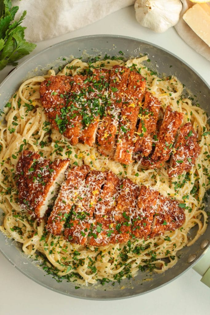Roasted garlic lemon pasta topped with crispy chicken and herbs.