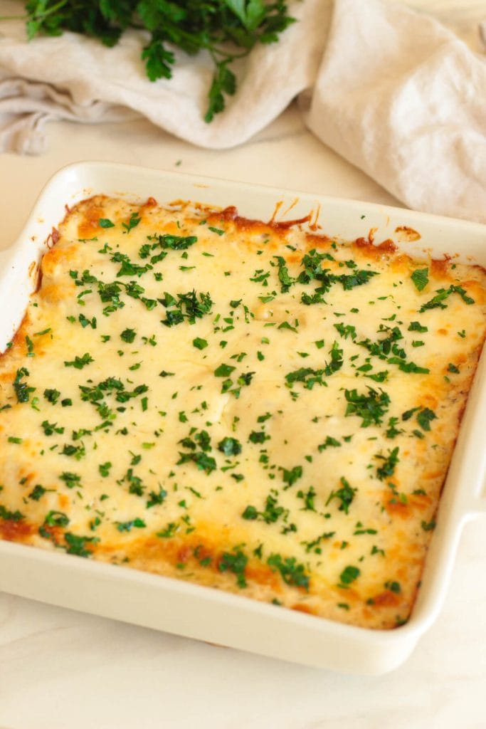 chicken alfredo lasagna rolls in a baking dish