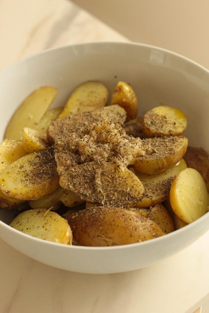 potatoes in a bowl with seasoninga