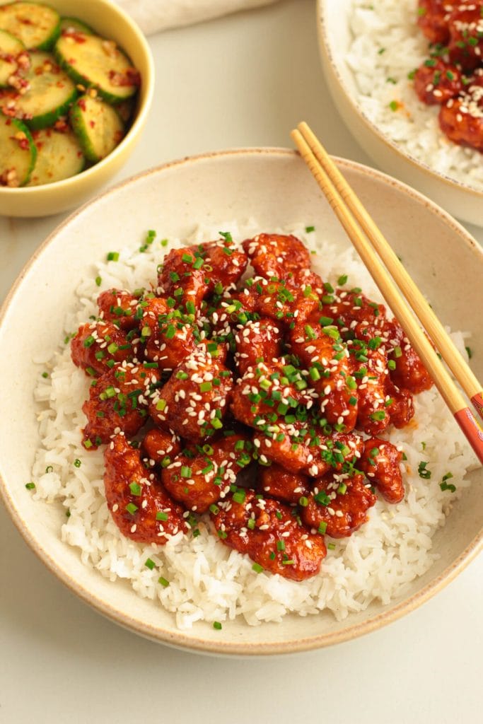 crispy Korean chicken bites served on a bed of rice