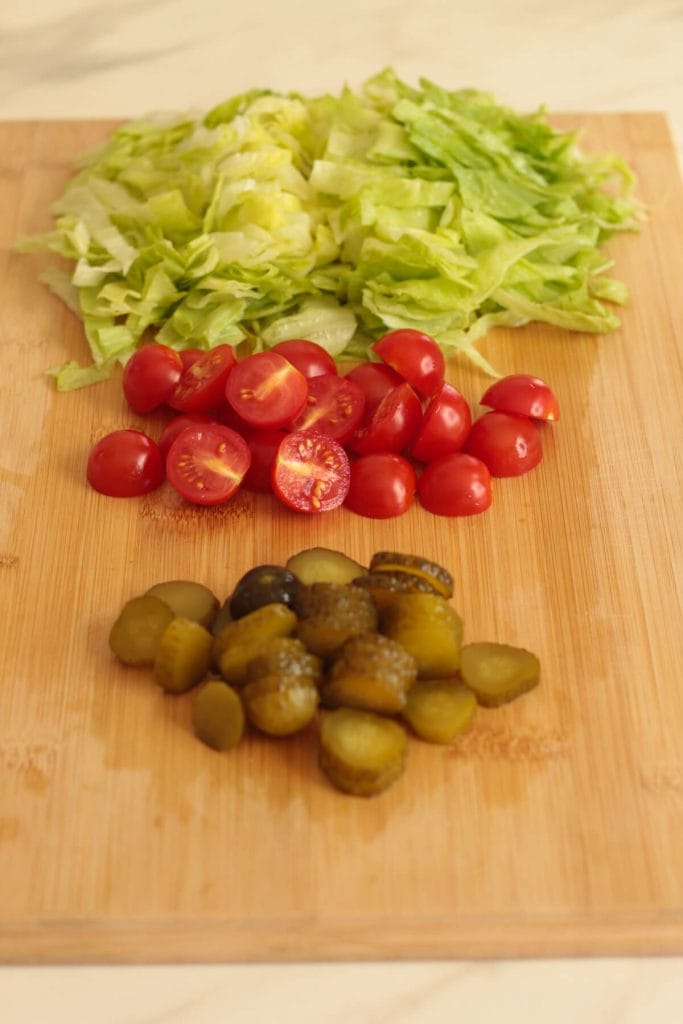 burger veggies chopped on a board