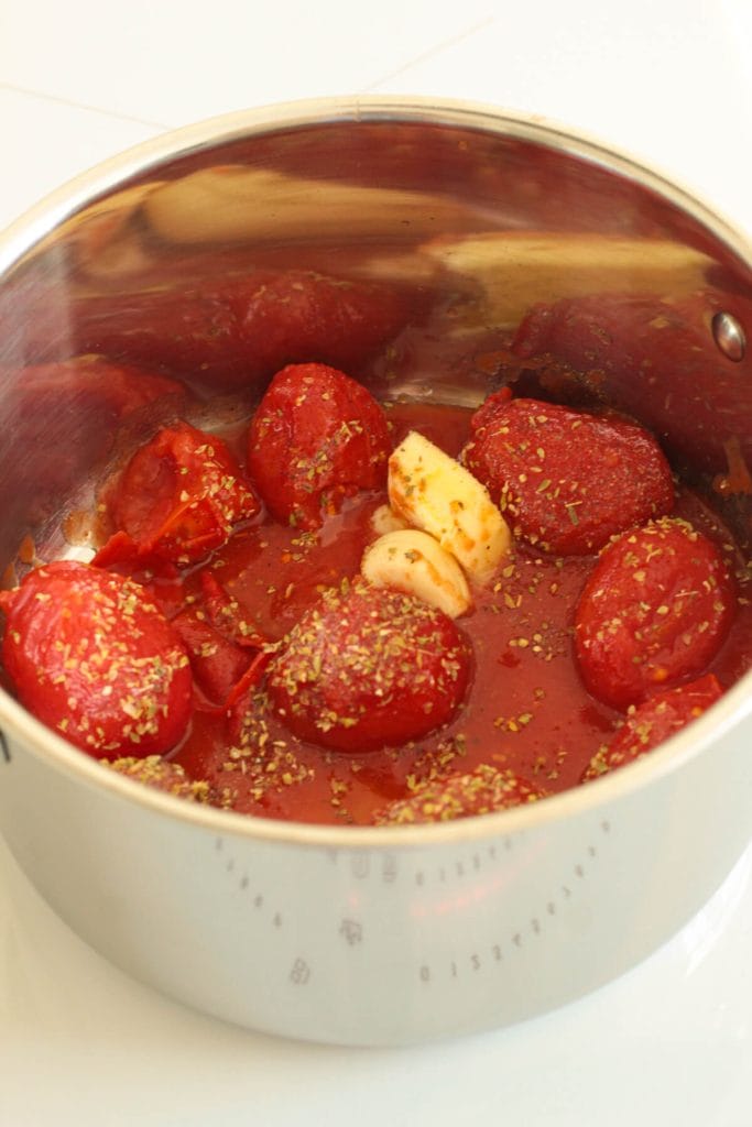 tomatoes with garlic, oregano and butter in a pot