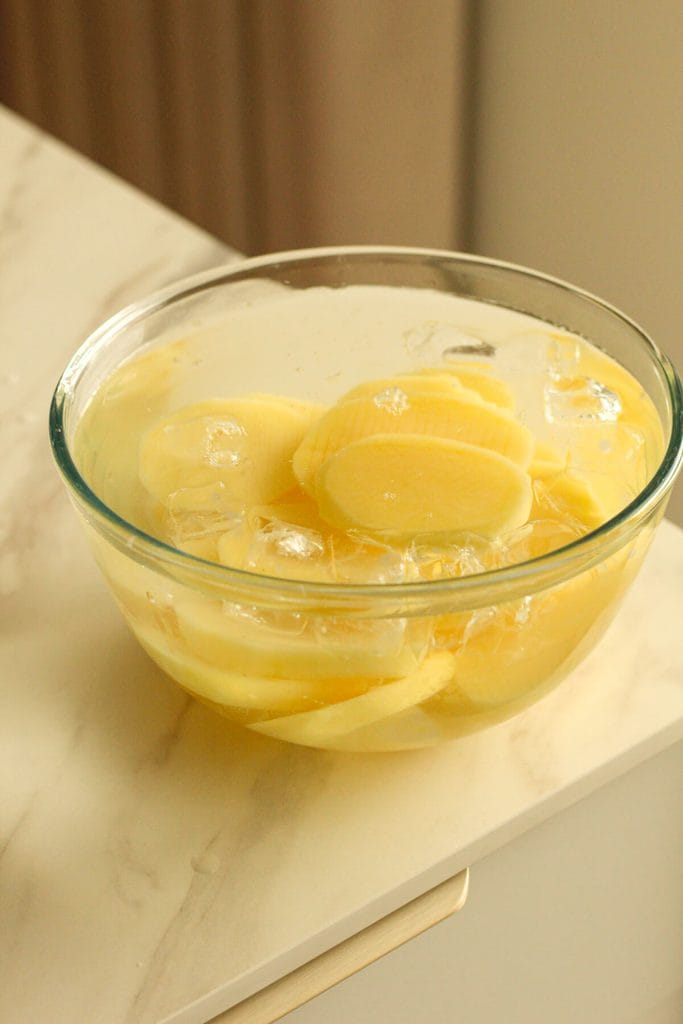 potato slices in cold water