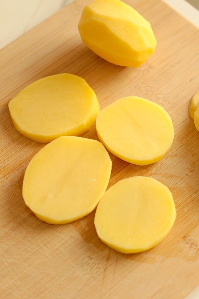 potato slices on a chopping board