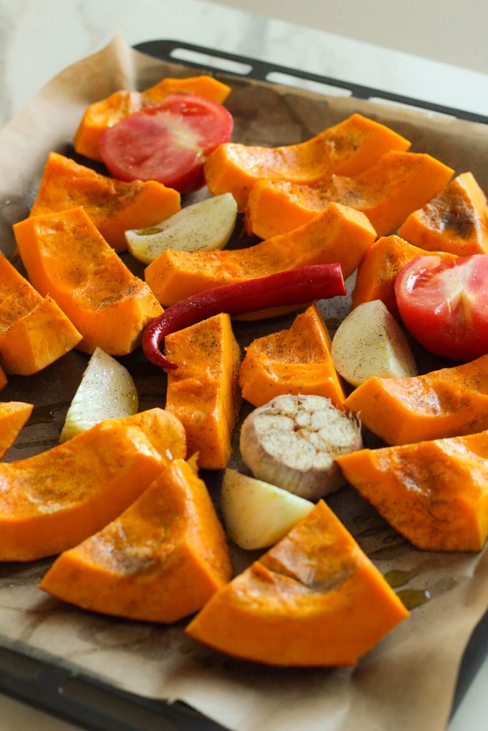 pumpkin pieces on a baking tray